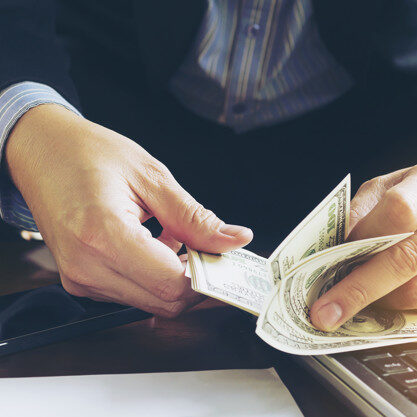 Business man counting dollar banknote - online business concept